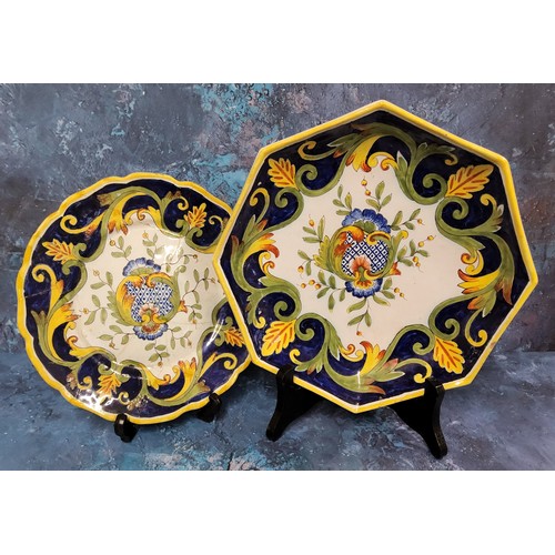 31 - A Continental maiolica style octagonal plate, decorated with stylised foliage and scrolls, in yellow... 