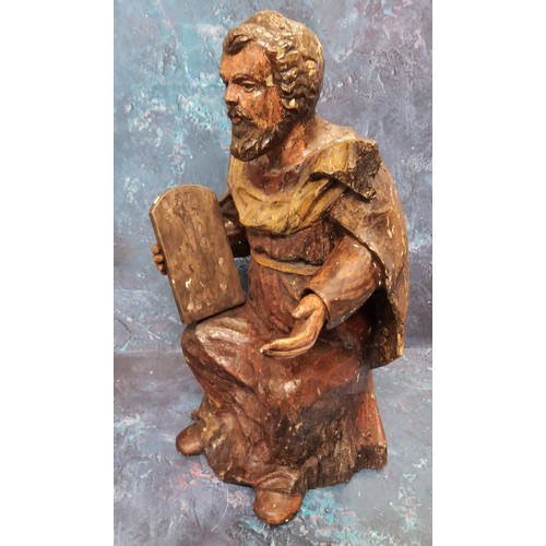 88 - A '17th century' Continental painted softwood figure, Moses, seated, holding a tablet, 44cm high