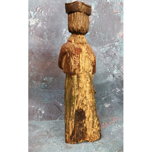 136 - An 18th century polychrome carving, of a lawyer, standing in robes, holding a book, 30.5cm high