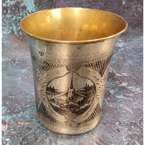 185 - A Russian silver and niello flared cylindrical beaker, engraved with buildings, 9cm high, Mikhail Di... 