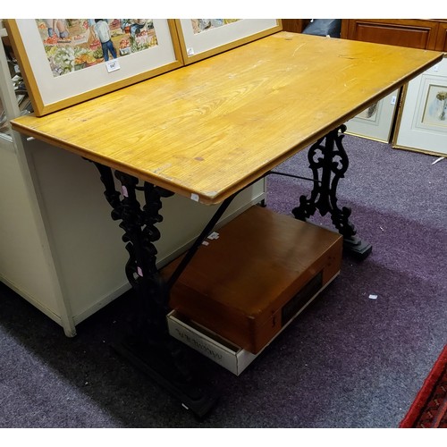 888 - A cast iron pub table, rectangular top, the base cast with masks and scrolls, 71cm high, 100cm wide