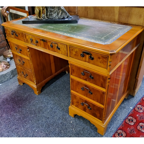 889 - A reproduction burr yew pedestal desk, green tooled leather inlay, three drawers to frieze, each ban... 