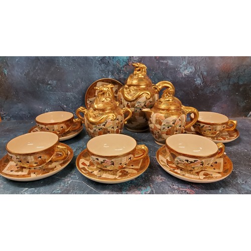 23 - A Japanese satsuma tea service, each typically decorated in with ladies on panels, gilt dragon handl... 