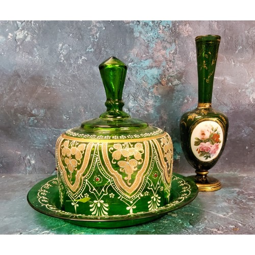 28 - A 19th century Bohemian emerald glass bottle vase, with oval panel painted with flowers, the ground ... 