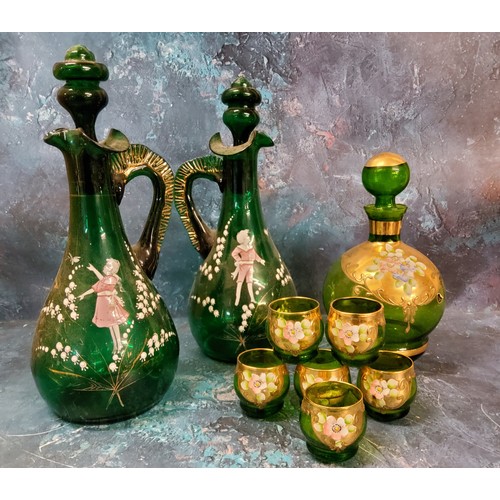 31 - A pair of Mary Gregory green glass decanters, painted with a boy and a girl amongst snowdrops, 32cm ... 