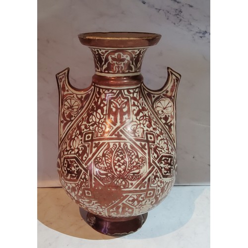 50 - A Hispano-Moresque copper lustre two handled vase, 22.5cm high