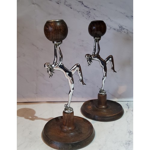 70 - A pair of Art Deco oak and chrome plated figural candlesticks, with naked ladies holding the sc... 