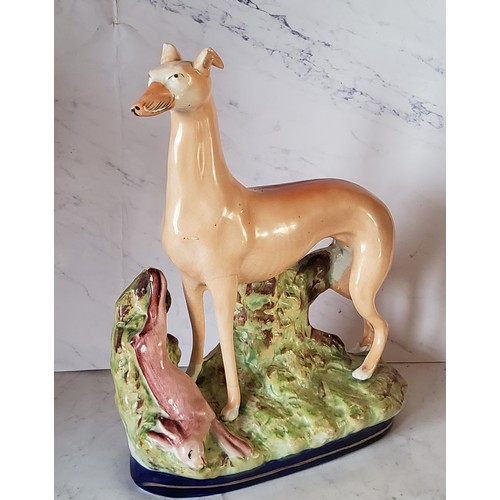 75 - A large Staffordshire greyhound, standing, gilt line cobalt blue base, 27cm high, c.1880