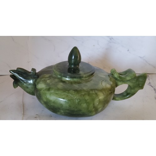 94 - A Chinese Jade teapot and cover,  bird spout,  bud knop, 17m wide