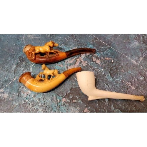 114 - A Victorian meerschaum pipe, carved with a horse, amber mouth piece;  another;  a clay pipe (3)