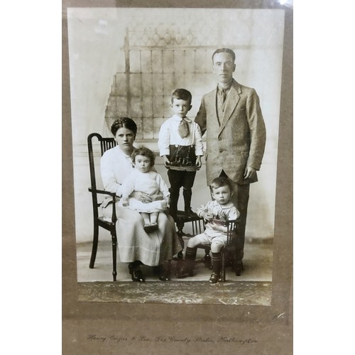 616 - An Edwardian family portrait, the little boy holding a scratch built model of a ship, the other hold... 