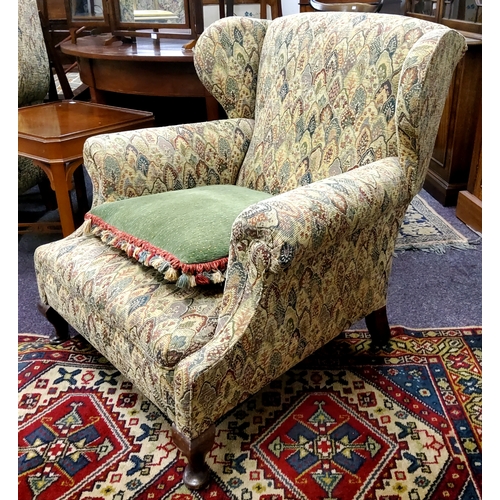 619 - An early 20th century wingback club chair, tapestry type upholstery c.1930