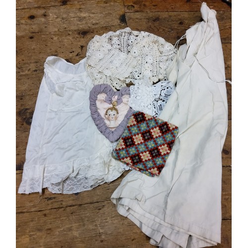 104 - Textiles - a Victorian cotton night gown;  silk and lace child's clothes;  a heart shaped ... 