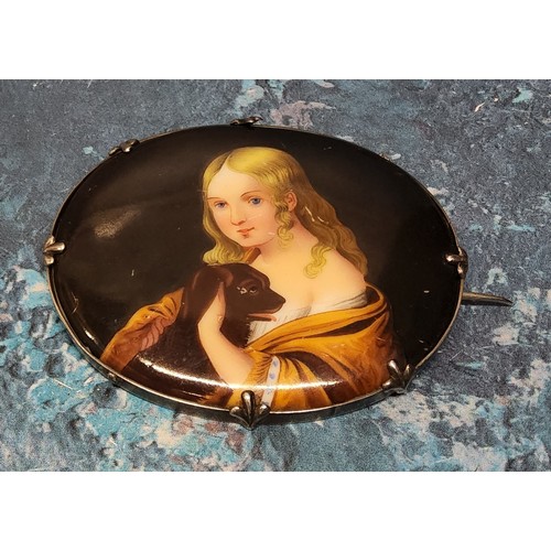 252 - A white metal mounted hand painted brooch depicting a young girl and her dog, 5.3 x 6.5cm