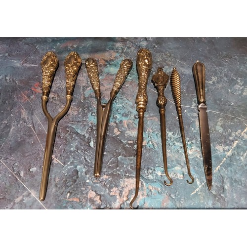 278 - A pair of Victorian silver hafted glove stretchers;  another;    three silver hafted ... 