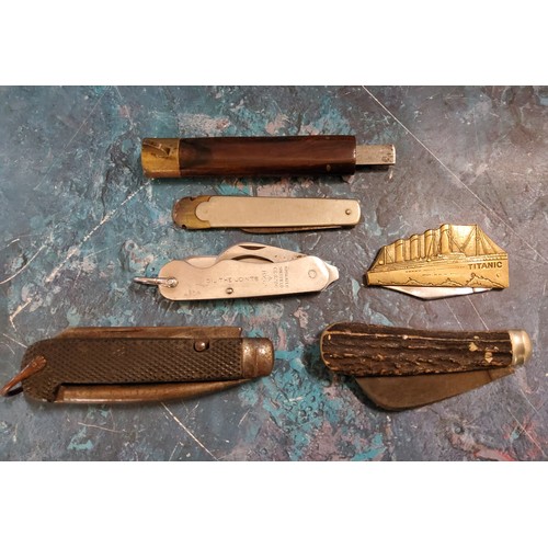 304 - A Titanic folding pen knife;  a horn hafted folding pen knife;  a military pen knife, Oil ... 