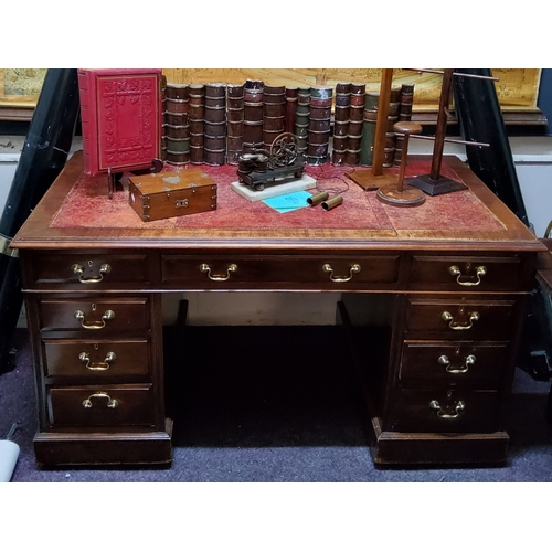 404 - A tooled leather inlaid twin pedestal mahogany desk, three drawers to frieze above two banks of draw... 