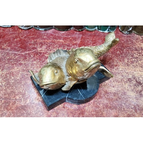 536 - An unusual bronze desk weight, Pisces, cast with two gilt bronze fish, shaped marble base, 18cm wide