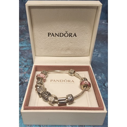 293 - A Pandora silver charm bracelet, ten charms including silver and pink glass, clips, rabbit, school s... 