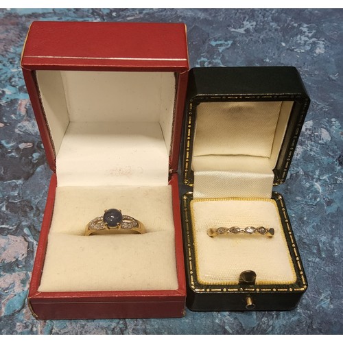 298 - A 9ct gold ring, claw set with a round blue stone cabochon, the shoulders set with diamond chips, si... 