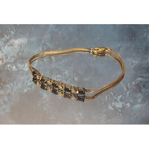 377 - A 14ct gold bracelet, the five central links claw set with blue oval stones, with four diamond chips... 