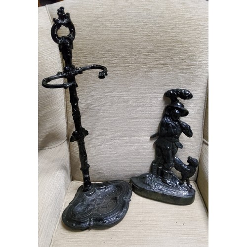 522 - A Victorian style cast iron stick stand, 64cm high;  an iron door stop, cast with forester and his d... 