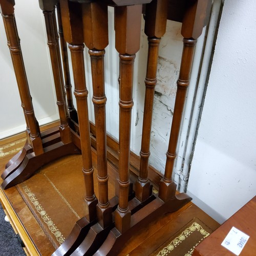 553 - A nest of Regency style occasional tables; a tooled leather inlaid wine table (2)