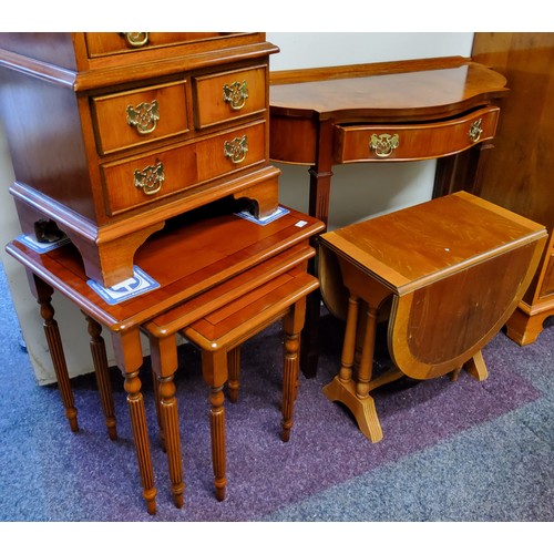 555 - A Minster yew serpentine fronted hall table, drawer to frieze, 77cm high, 80cm wide;  a nest of... 