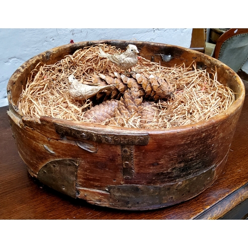 598 - A rustic farmhouse metal bound bowl, riveted and restored with ironwork straps and staples