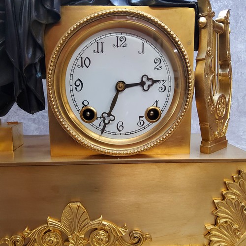 575 - A French gilt metal and bronzed clock, the dial with Arabic numerals, twin winding holes, striking o... 