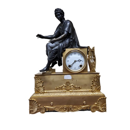 575 - A French gilt metal and bronzed clock, the dial with Arabic numerals, twin winding holes, striking o... 