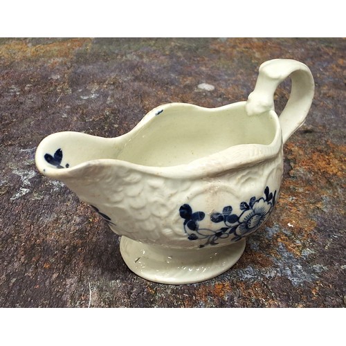 217 - A Liverpool James Pennington strap moulded creamboat, painted in underglaze blue with flowers, bitin... 