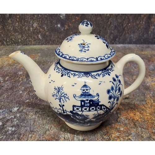 169 - A Lowestoft teapot and cover,  painted in underglazed blue with pagoda and fence, ball finial, 12.5c... 