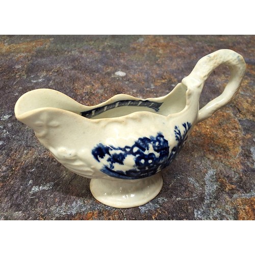 218 - A Liverpool John & Jane Pennington cream jug, moulded in relief with shells, printed in undergla... 