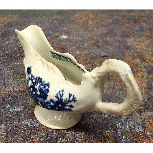 218 - A Liverpool John & Jane Pennington cream jug, moulded in relief with shells, printed in undergla... 