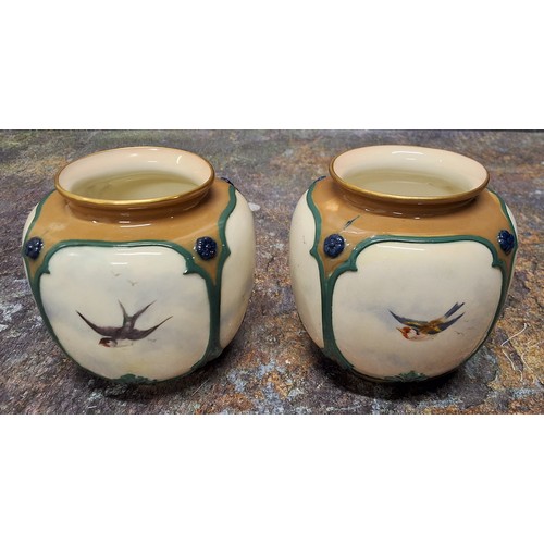 231 - A pair of Royal Worcester Hadley style vases,  moulded with panels and painted with birds in flight,... 