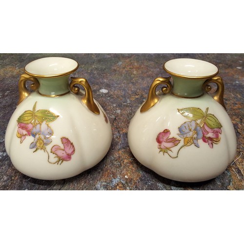 206 - A pair of Royal Worcester lobed ovoid two  handled vases,  painted with flowers inprismatic enamels,... 