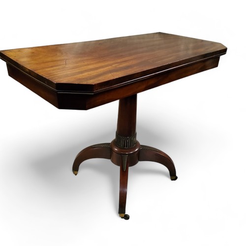 611 - A George IV mahogany tea table, canted rectangular top, spreading cylindrical column, four scroll le... 