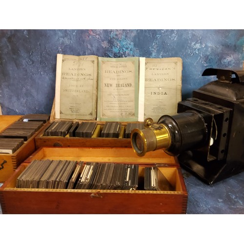 619 - An early 20th century magic lantern projector, 29cm high, 43cm long, c.1910;  Magic Lantern Slides -... 