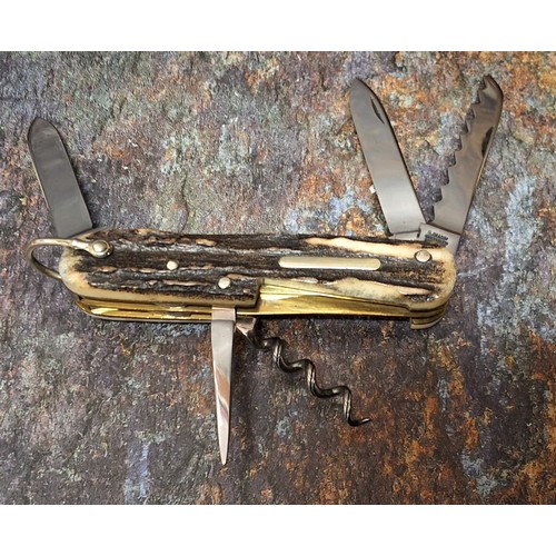 632 - A Stan Shaw pocket knife, two blades, saw, awl and corkscrew, stag scales, vacant cartouche, brass l... 