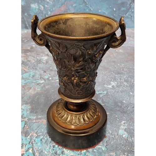 637 - A 19th century bronze urn, of waisted cylindrical form, cast with scrolling foliage, scroll handles,... 