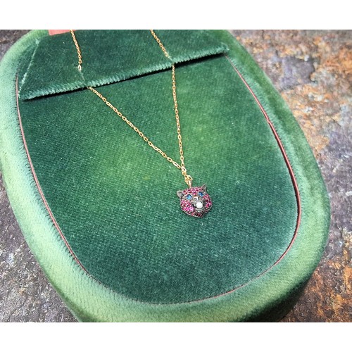 103 - A Gucci Le Marche des Merveille 18ct gold necklace, stamped Gucci, 750, a white metal pendant in the... 