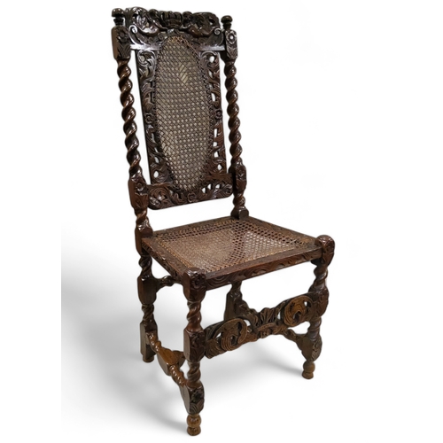 653 - A Carolean carved walnut hall chair, 17th century, the caned back panel flanked by barley twist side... 