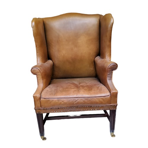 656 - A George III mahogany wingback armchair, c1780, in close nailed leather upholstery, seat height 47cm... 