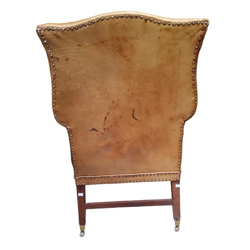 656 - A George III mahogany wingback armchair, c1780, in close nailed leather upholstery, seat height 47cm... 