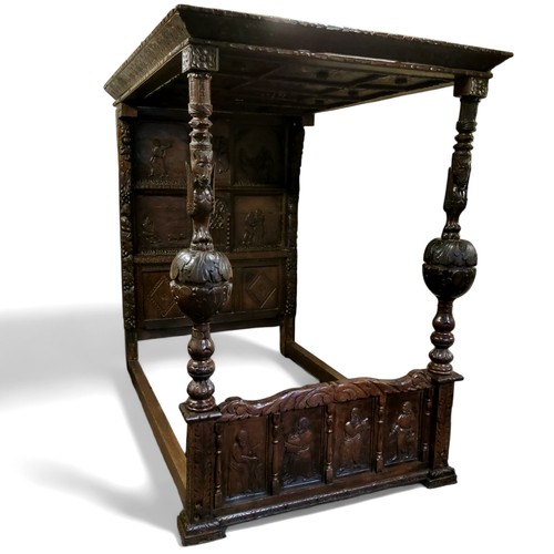 662 - An 'Elizabeth I' oak tester bed, the oversailing thirteen fielded panelled tester canopy in relief w... 