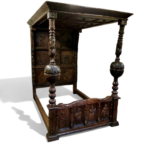 662 - An 'Elizabeth I' oak tester bed, the oversailing thirteen fielded panelled tester canopy in relief w... 