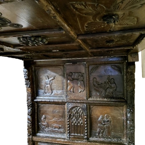 662 - An 'Elizabeth I' oak tester bed, the oversailing thirteen fielded panelled tester canopy in relief w... 