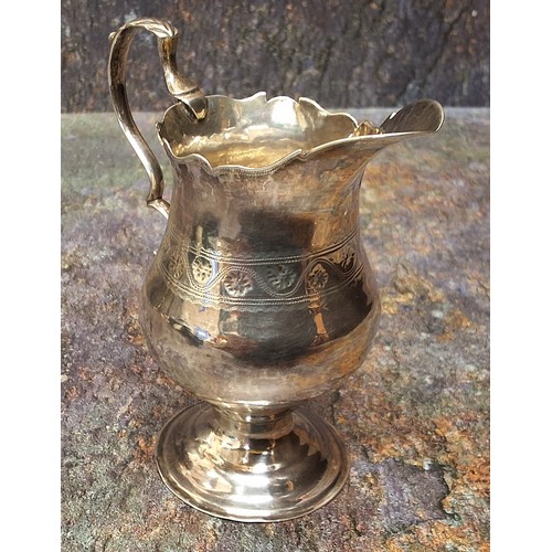 43 - A George III silver pedestal cream jug, acanthus-capped scroll handle, shaped circular foot, stipple... 