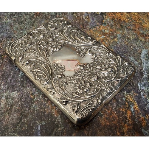 140 - An Edwardian silver rounded rectangular visiting card case, embossed with  leafy scrolls and flowers... 